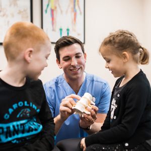 Chiropractor Charlotte NC Logan Hiers With Children